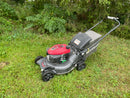 Honda push mower looking at the front left hand side, you see the green and grey bag or mulch selector lever