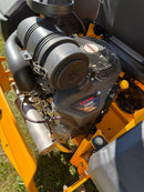 A Kawasaki DX260V 4-stroke diesel engine mounted on a yellow machine frame, photographed outdoors on grass.