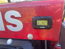 Close-up of a red piece of heavy machinery with a digital hour meter displaying 102.5 hours,